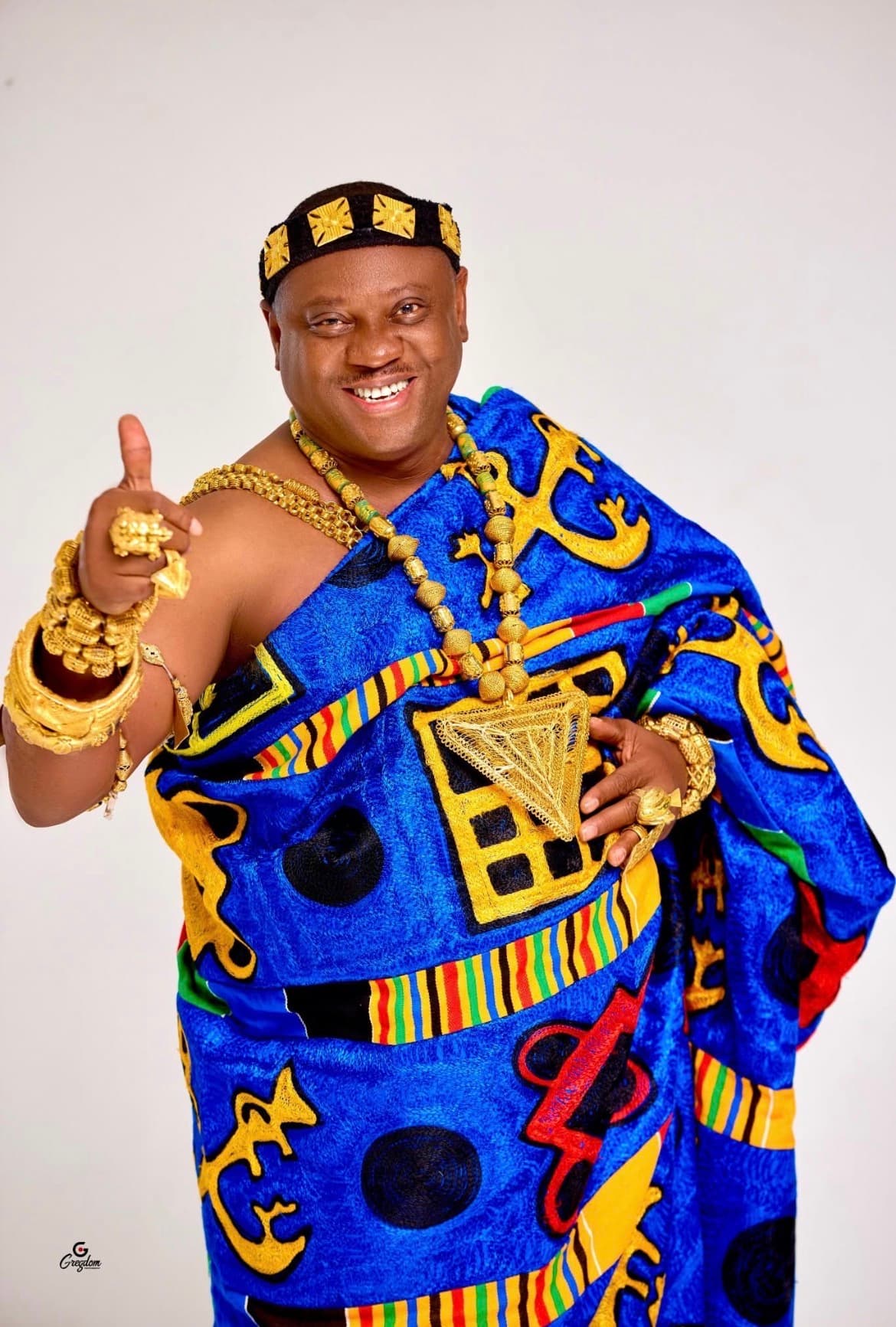 Obrempong Ameyaw Amponsem II in blue kente with royal adornments